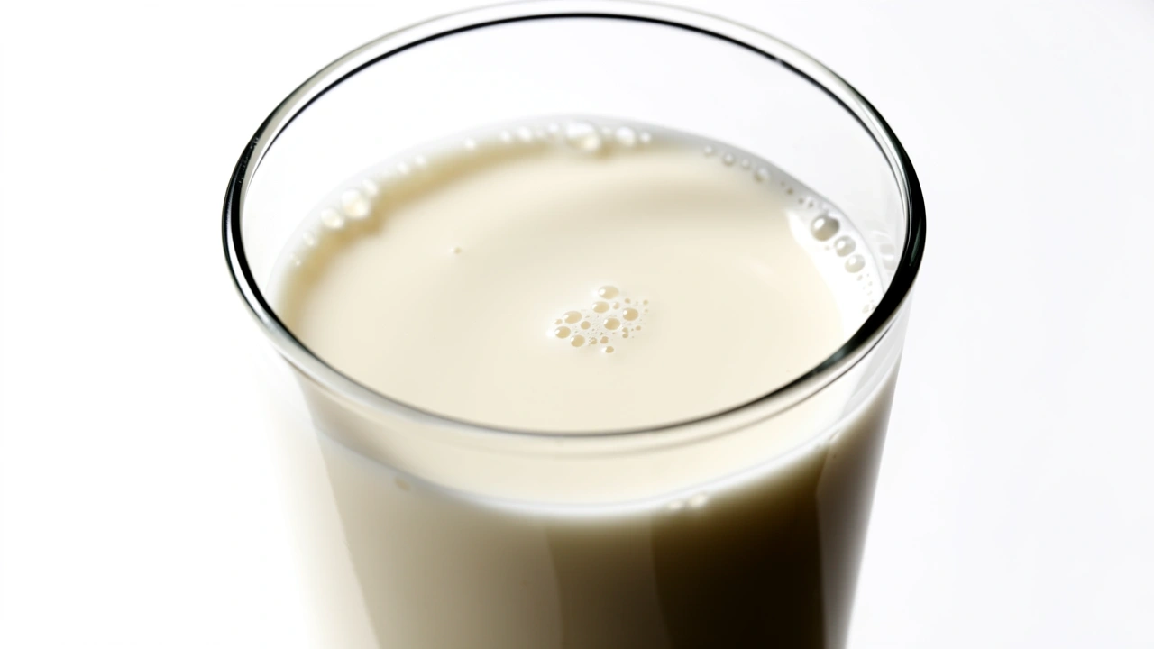 Thin watery steamed milk with no foam in a clear glass